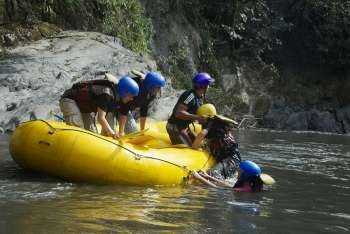 Side profile of three people pulling their friends on the raft