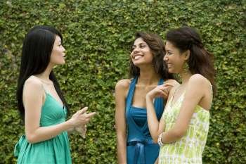 Three young women gossiping