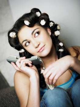 Close-up of a teenage girl holding a telephone