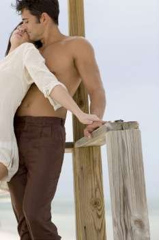 Close-up of a young couple standing on a pier