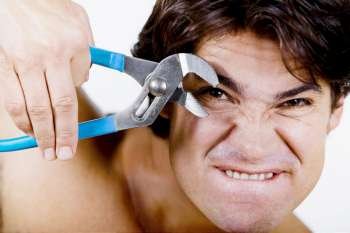 Portrait of a mid adult man holding pliers