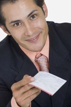 Portrait of a businessman holding a check and smiling