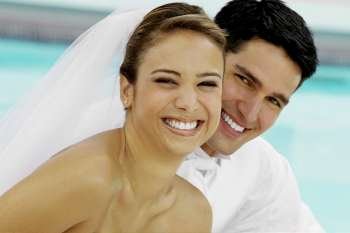 Portrait of a newlywed couple smiling