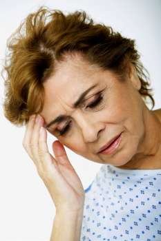 Close-up of a senior woman suffering from a headache