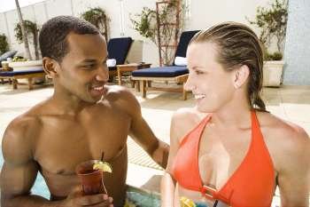 Close-up of a young couple looking at each other in a swimming pool