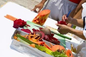 Close-up of a person´s hands carving fruits and vegetables, Cancun, Mexico