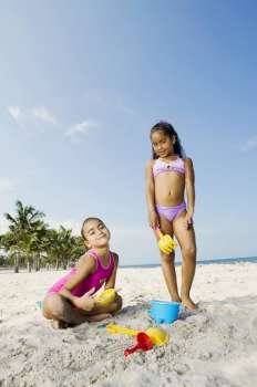 Portrait of two girls playing on the beach