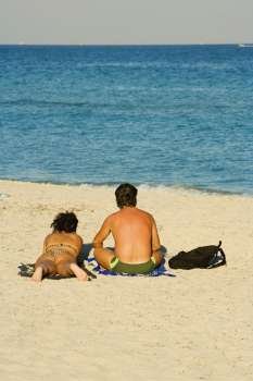 Rear view of a man and woman on the beach