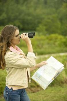 Side profile of a girl looking through a pair of binoculars