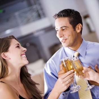 Mid adult man and a young woman raising a toast