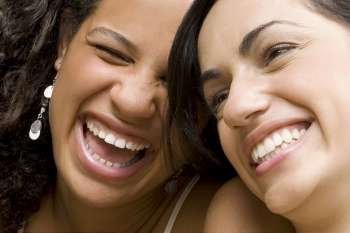 Close-up of a young woman smiling with her friend