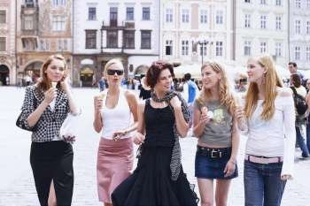 Group of young women walking with ice-cream cones 
