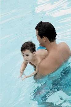 Father teaching his son how to swim