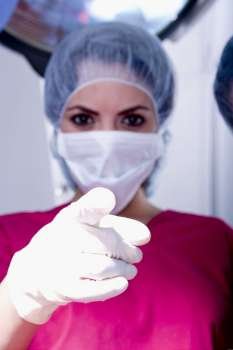 Portrait of a female surgeon pointing forward