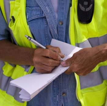 Close-up of a construction worker writing on paper