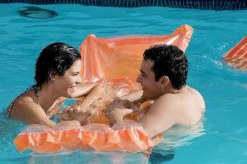 Side profile of a young couple in a swimming pool