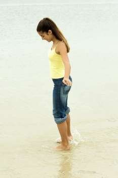 Side profile of a girl standing on the beach