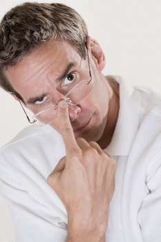 Portrait of a mid adult man adjusting his eyeglasses