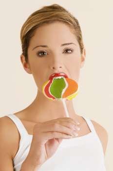 Portrait of a young woman eating a lollipop
