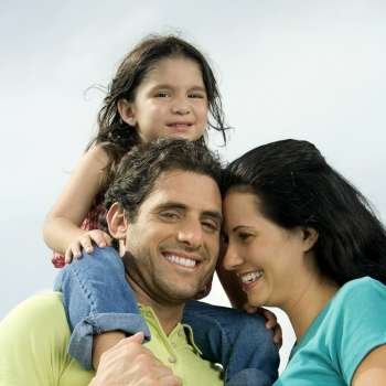 Low angle view of parents and their daughter smiling