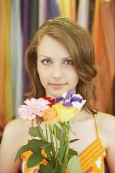 Portrait of a teenage girl holding a bouquet of flowers