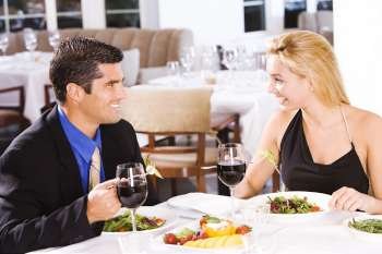 Mid adult man and a young woman sitting in a restaurant