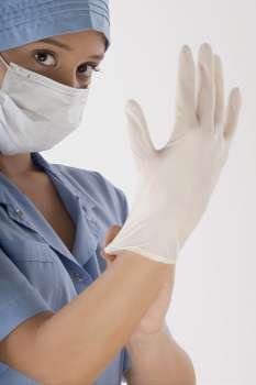 Female surgeon wearing a surgical glove
