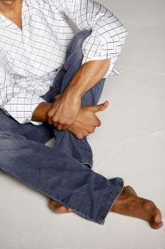High angle view of a mid adult man sitting on the floor