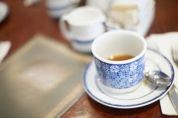 Close-up of a tea cup and a saucer on the table