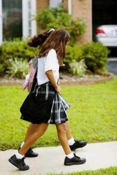 Side profile of two schoolgirls walking