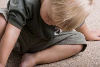 High angle view of a boy sitting on the floor