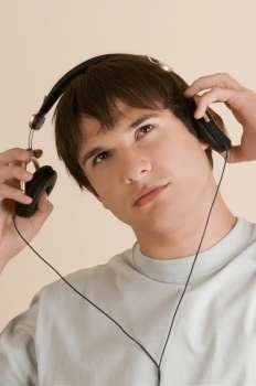 Close-up of a young man listening to music