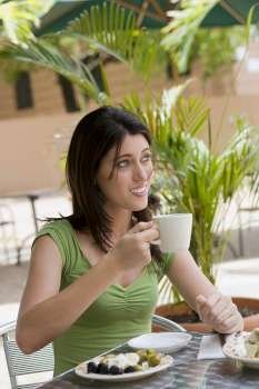 Close-up of a teenage girl drinking tea at a restaurant