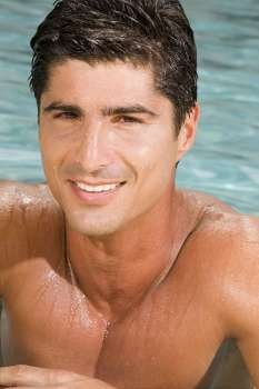 Portrait of a mid adult man smiling in a swimming pool