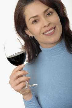 Portrait of a mid adult woman holding a glass of red wine