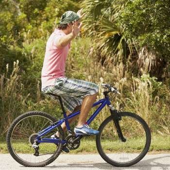 Side profile of a young man performing tricks on a bicycle