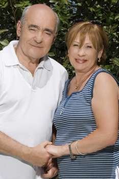 Portrait of a senior couple holding hands and smiling