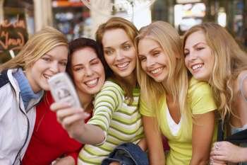Five young women taking a photograph of themselves 