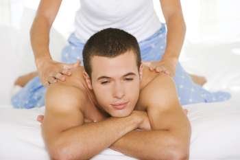 Close-up of a young man getting a shoulder massage
