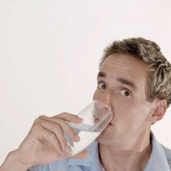 Portrait of a mid adult man drinking a glass of water