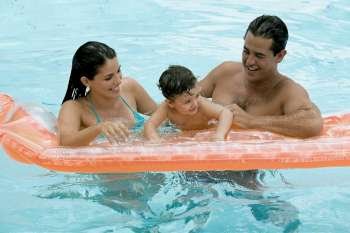 Parents with their son in a swimming pool