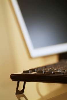 Close-up of a computer keyboard and a computer monitor