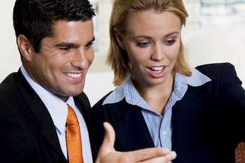 Close-up of a businessman and a businesswoman talking