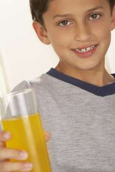 Portrait of a boy holding a glass of juice