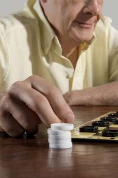 Senior man playing checkers