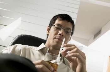 Low angle view of a businessman holding a drink