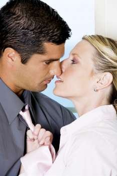 Close-up of a businessman kissing a businesswoman