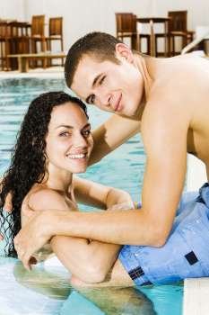 Portrait of a young couple in a swimming pool