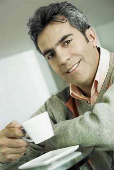 Portrait of a mature man holding a tea cup