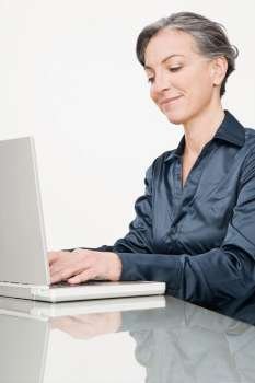 Businesswoman working on a laptop and smiling